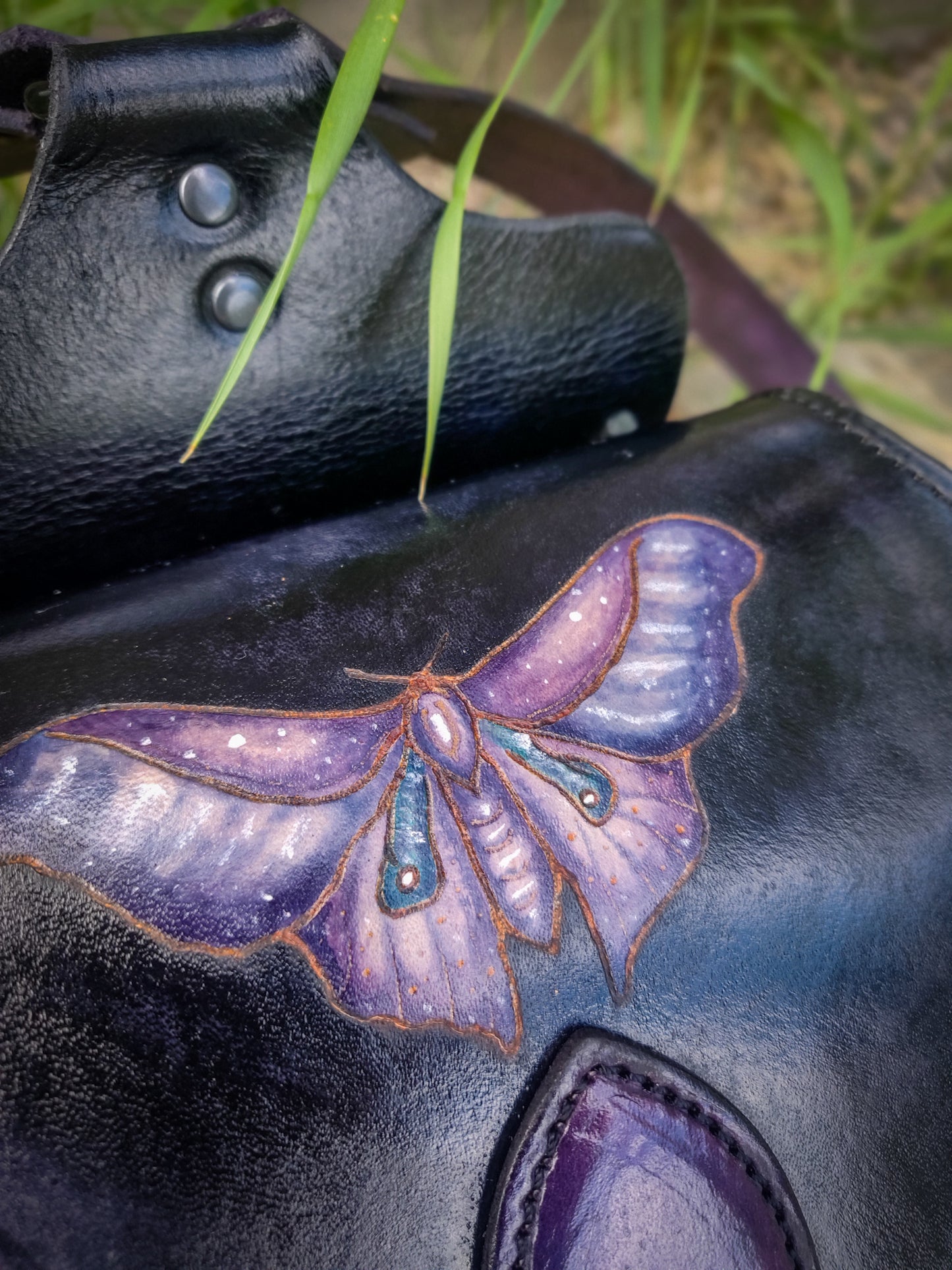 Leather backpack with moth design