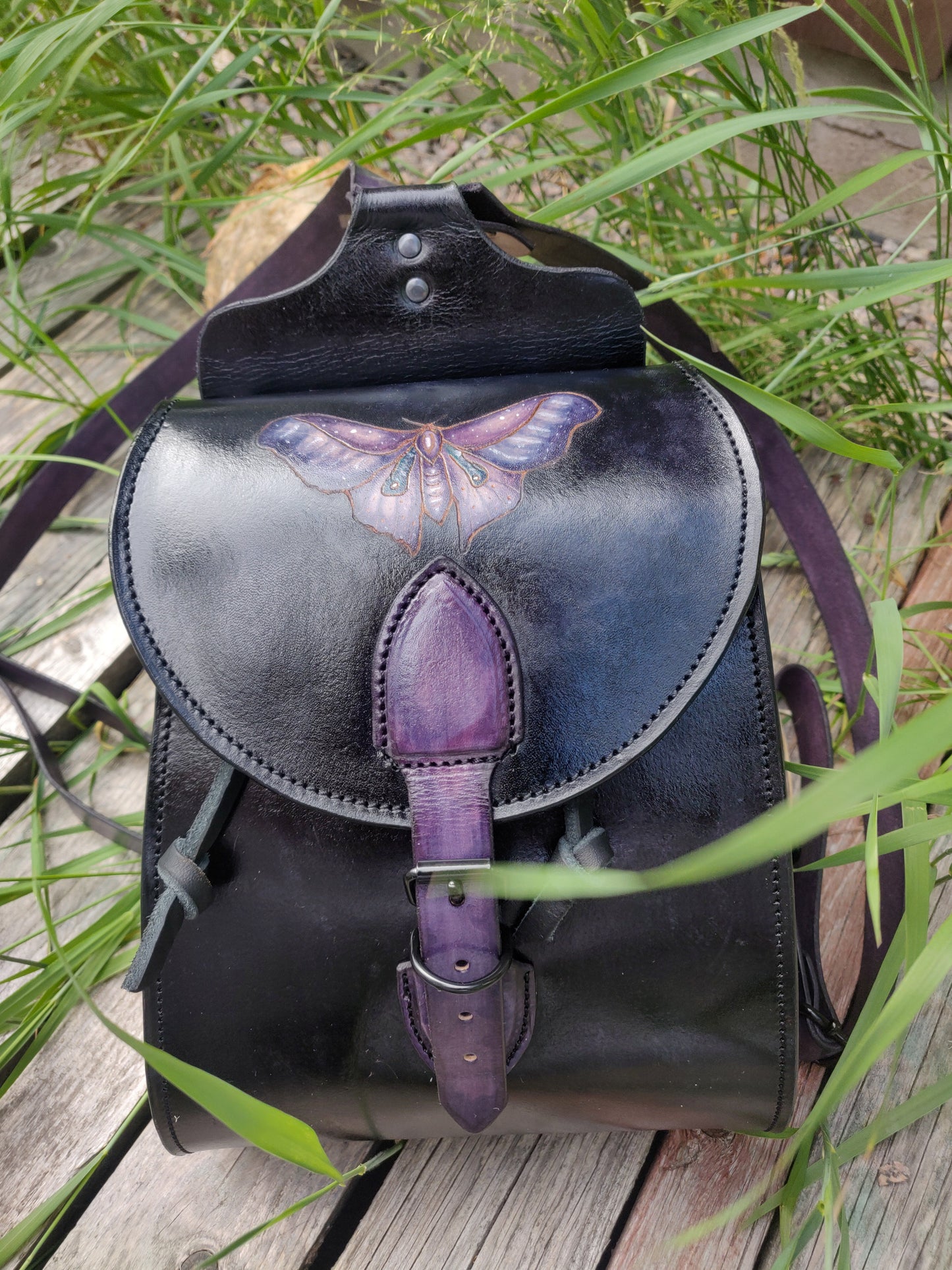 Leather backpack with moth design